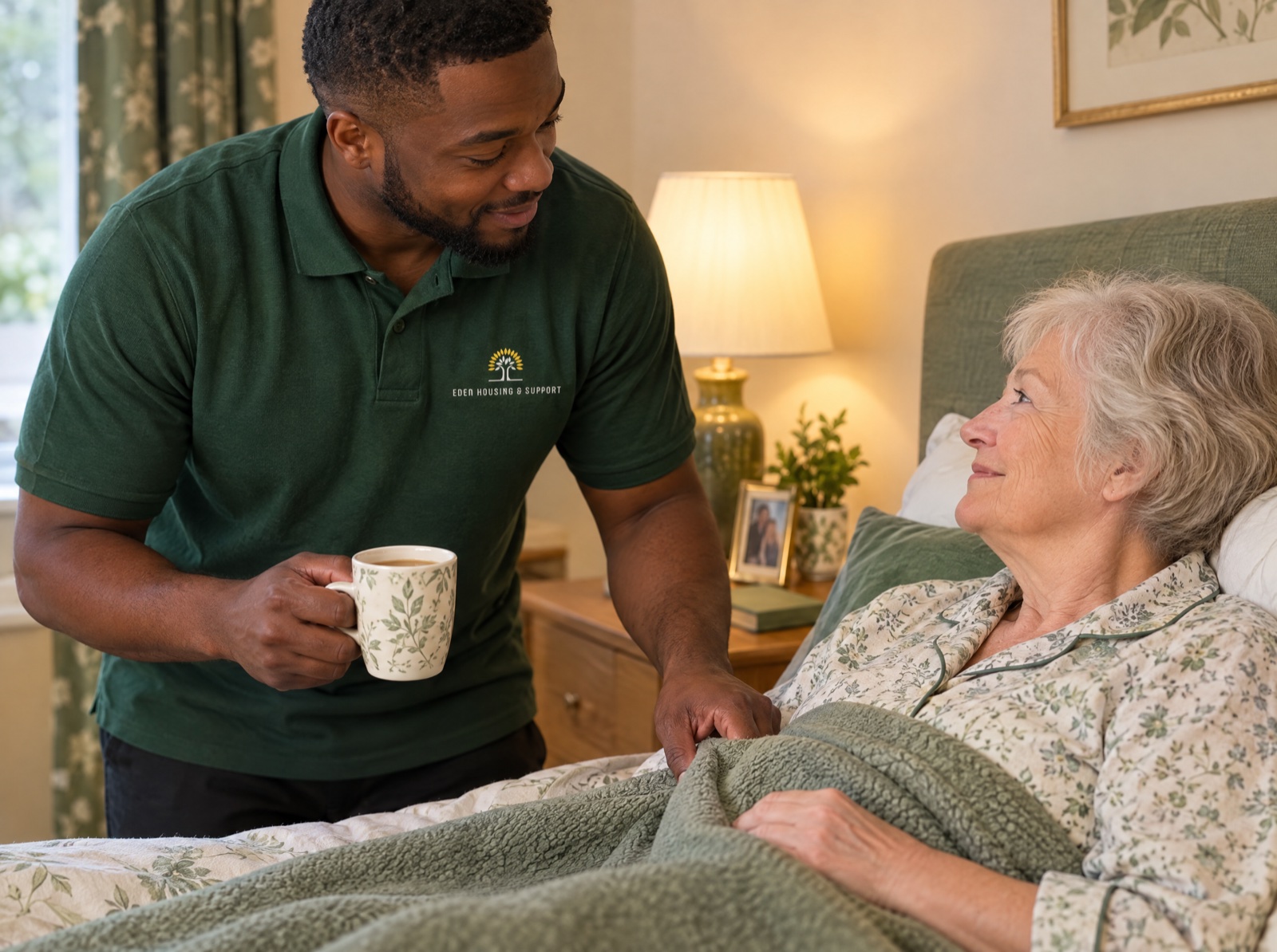 Eden carer helping an older woman settle into bed during an evening care call in Shropshire