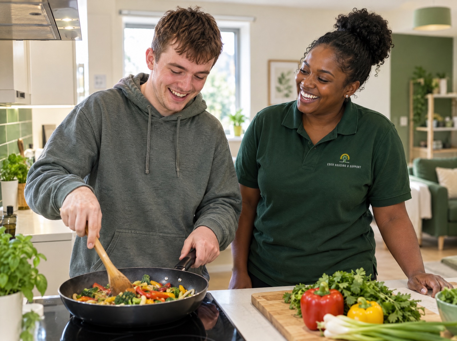 Young man cooking with his Eden support worker in a supported living home in Shropshire