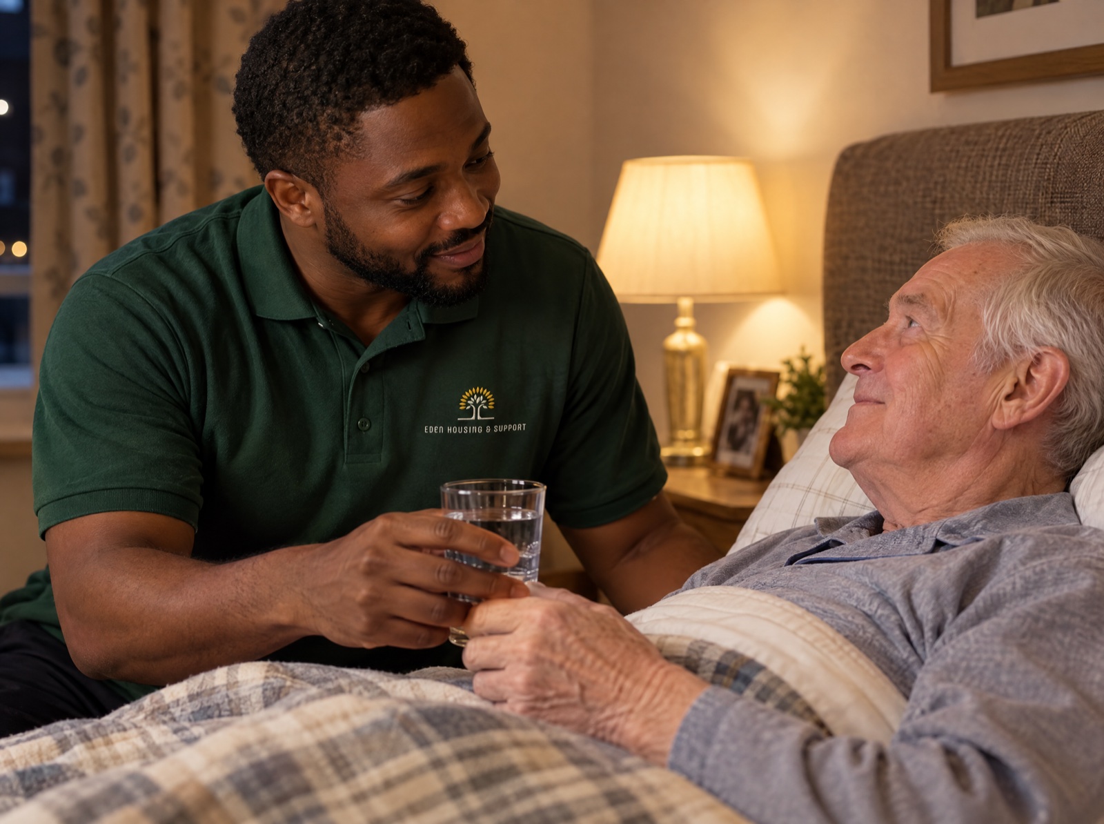 Eden night carer helping an older man with a drink during the night in Shropshire